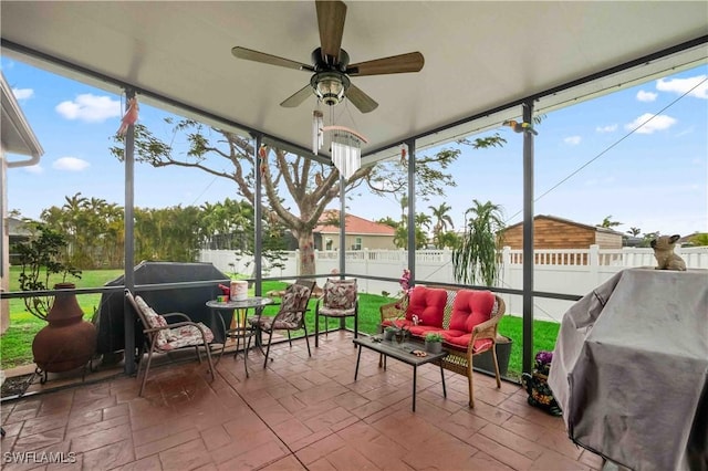 sunroom featuring plenty of natural light and ceiling fan