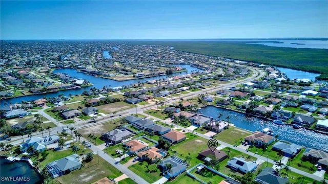 bird's eye view featuring a residential view and a water view