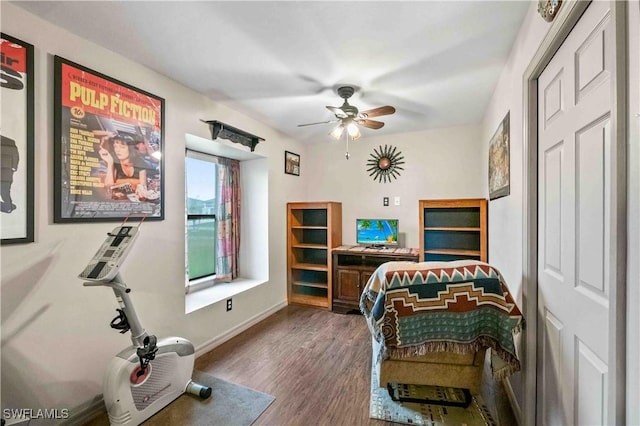 bedroom with baseboards, dark wood-type flooring, and a ceiling fan