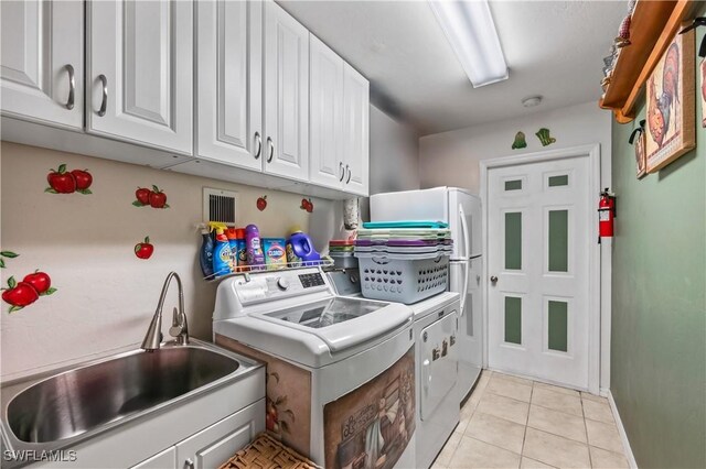 2725 SW 28th Pl, Cape Coral, FL 33914 - laundry area featuring cabinet space, washing machine and clothes dryer, and light tile patterned floors