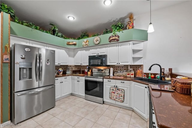 kitchen with a sink, dark countertops, tasteful backsplash, and stainless steel appliances