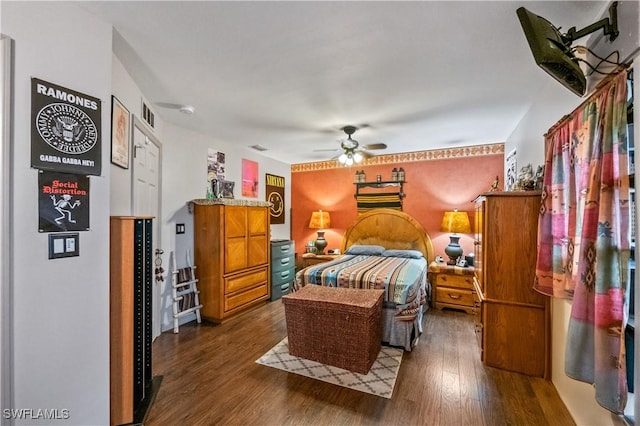 bedroom with visible vents, a ceiling fan, and dark wood-style flooring