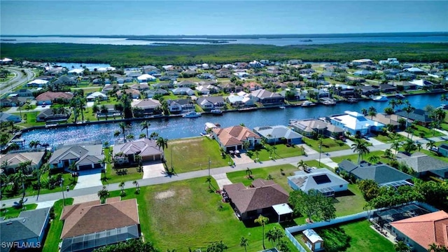 drone / aerial view featuring a residential view and a water view