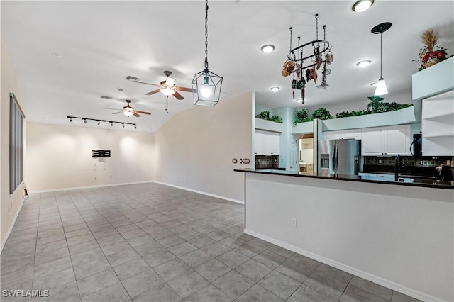 2725 SW 28th Pl, Cape Coral, FL 33914 - kitchen with stainless steel fridge with ice dispenser, dark countertops, ceiling fan, and decorative backsplash