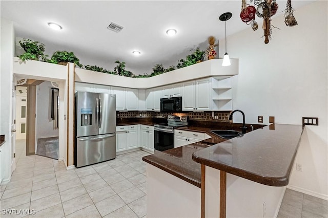 2725 SW 28th Pl, Cape Coral, FL 33914 - kitchen featuring appliances with stainless steel finishes, a sink, a peninsula, backsplash, and open shelves