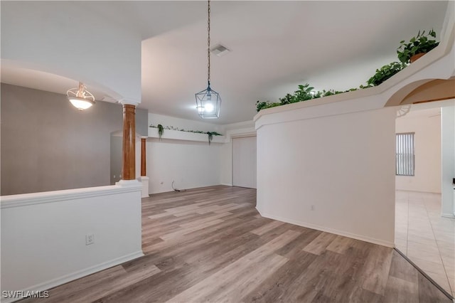 2725 SW 28th Pl, Cape Coral, FL 33914 - unfurnished room with wood finished floors, decorative columns, arched walkways, and baseboards