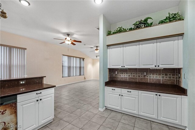 2725 SW 28th Pl, Cape Coral, FL 33914 - kitchen featuring ceiling fan, dark countertops, backsplash, light tile patterned flooring, and vaulted ceiling
