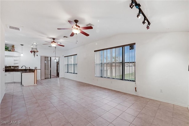 2725 SW 28th Pl, Cape Coral, FL 33914 - unfurnished living room featuring ceiling fan, light tile patterned floors, vaulted ceiling, a sink, and rail lighting
