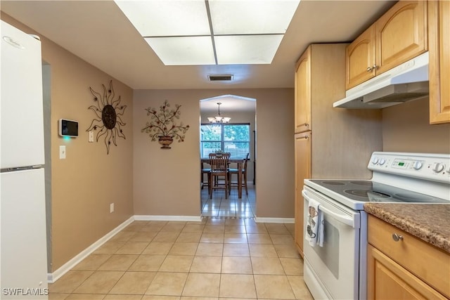 kitchen featuring visible vents, under cabinet range hood, light tile patterned floors, arched walkways, and white appliances