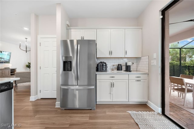 kitchen featuring light wood-type flooring, stainless steel appliances, and white cabinetry