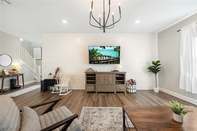 living area with stairway, baseboards, visible vents, and wood finished floors