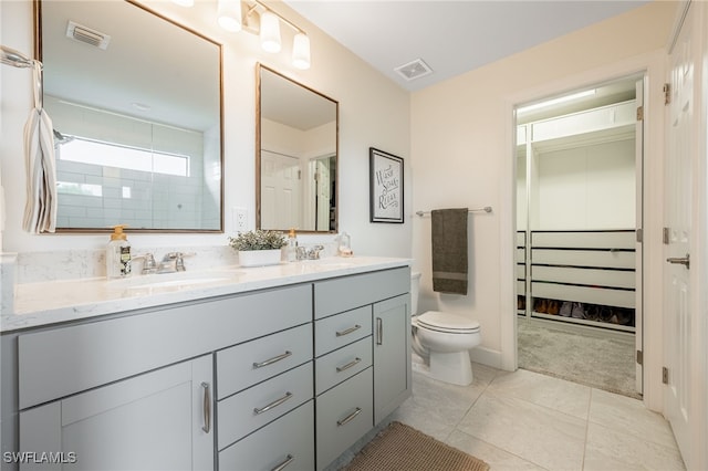 bathroom featuring double vanity, visible vents, and a sink