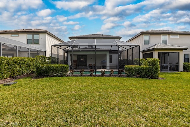 rear view of property with an outdoor pool, a yard, and glass enclosure