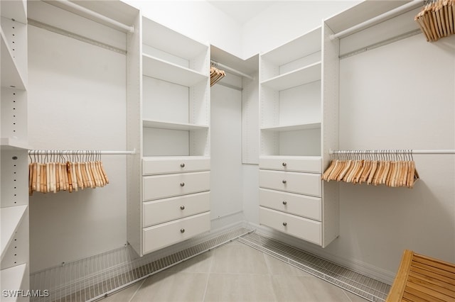 spacious closet with light tile patterned floors