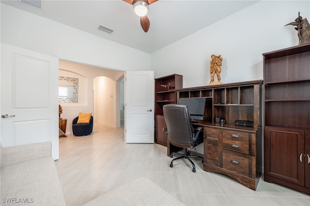 home office featuring arched walkways, visible vents, and ceiling fan