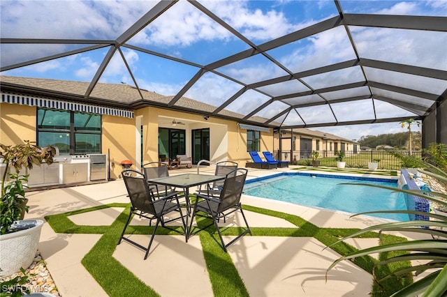 outdoor pool featuring a ceiling fan, exterior kitchen, a patio area, and fence