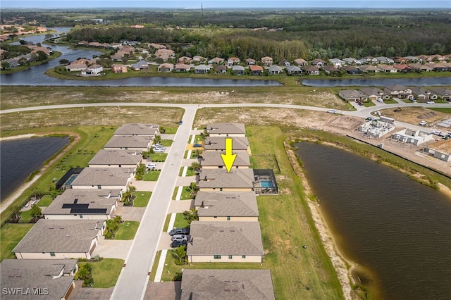 drone / aerial view featuring a residential view and a water view