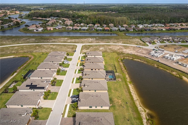 birds eye view of property featuring a residential view and a water view