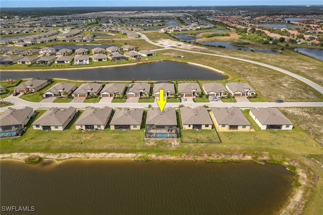 bird's eye view featuring a residential view and a water view