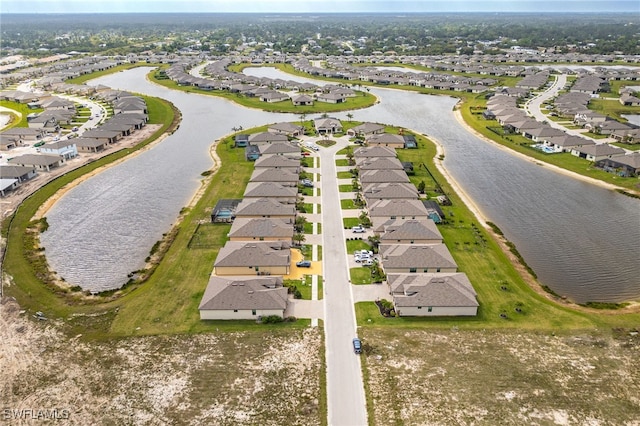 bird's eye view featuring a residential view and a water view