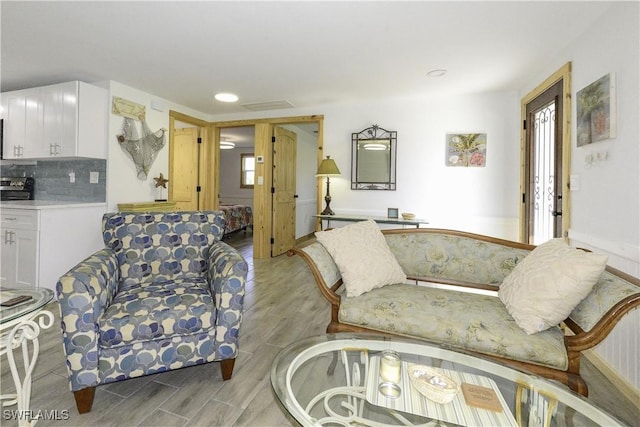 living room with light wood-style flooring and recessed lighting