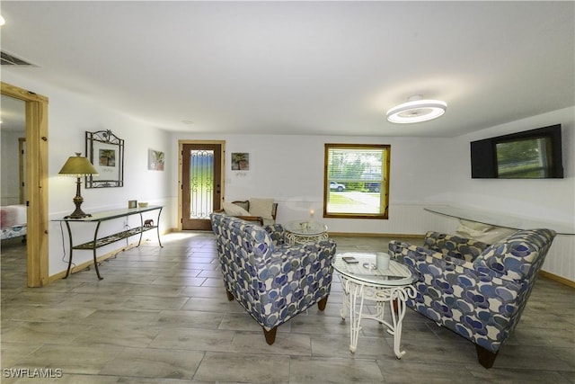 living room with visible vents and wainscoting