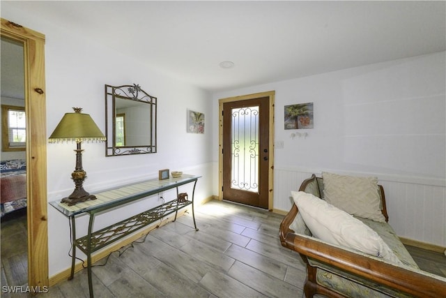 foyer featuring wainscoting and wood finished floors