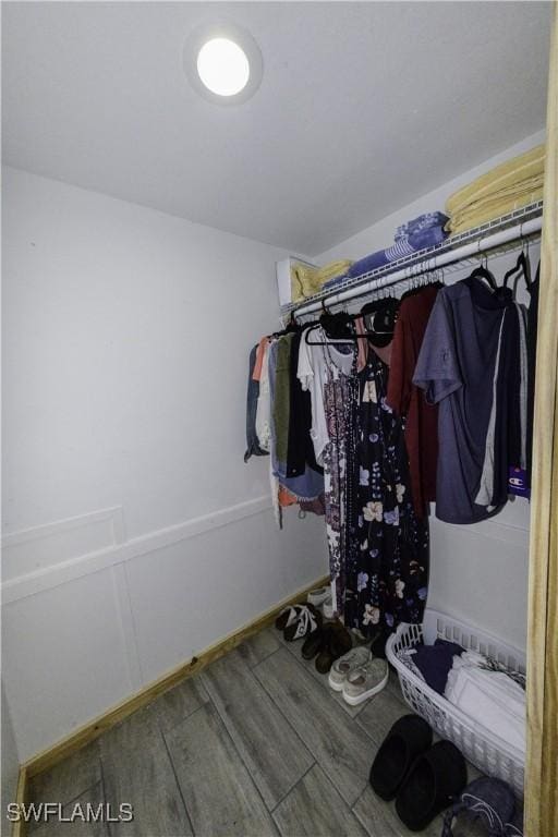 walk in closet featuring wood finished floors