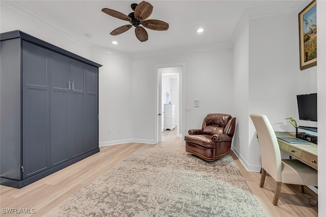 office space with light wood-style floors, crown molding, and baseboards