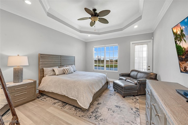 bedroom with light wood finished floors, a raised ceiling, ceiling fan, crown molding, and recessed lighting