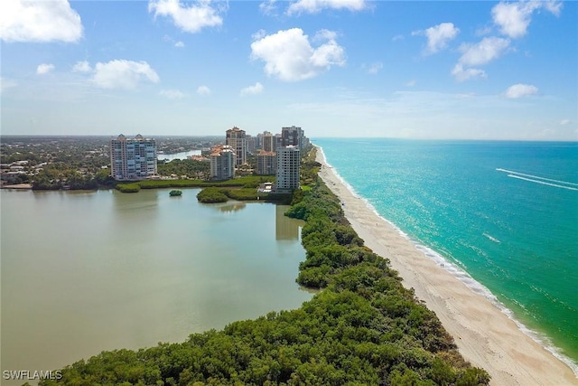 bird's eye view featuring a water view, a beach view, and a city view