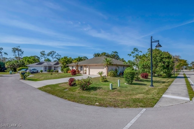 ranch-style house featuring an attached garage, driveway, and a front lawn