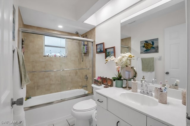 bathroom with toilet, bath / shower combo with glass door, and vanity