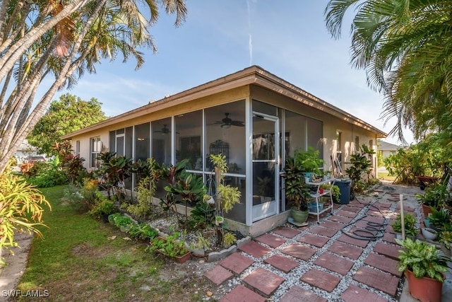 view of home's exterior with a sunroom