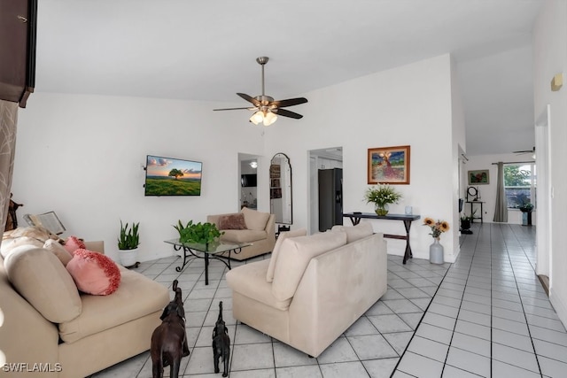 living area with high vaulted ceiling, light tile patterned flooring, and ceiling fan