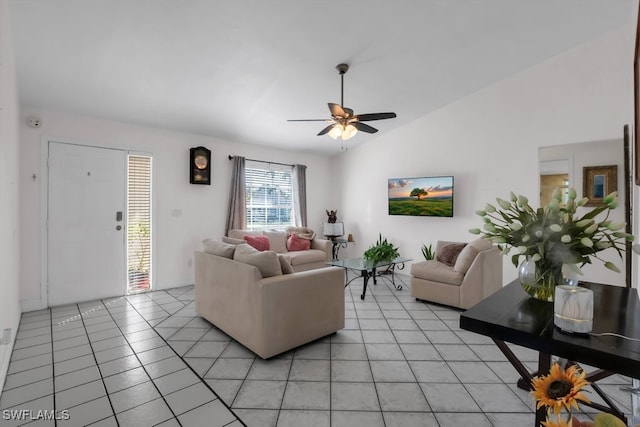 living room featuring ceiling fan, vaulted ceiling, and light tile patterned flooring