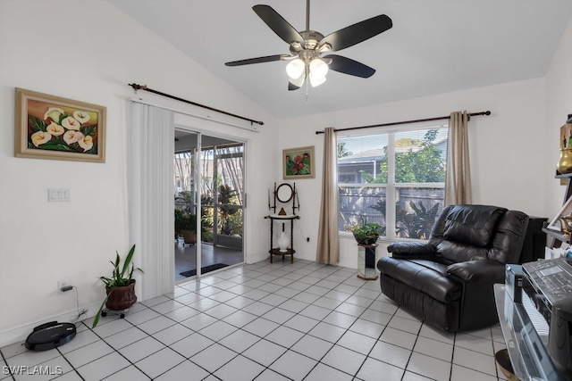 sitting room featuring lofted ceiling, light tile patterned flooring, a wealth of natural light, and a ceiling fan