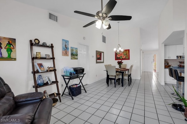 dining space featuring high vaulted ceiling, ceiling fan with notable chandelier, visible vents, and light tile patterned flooring