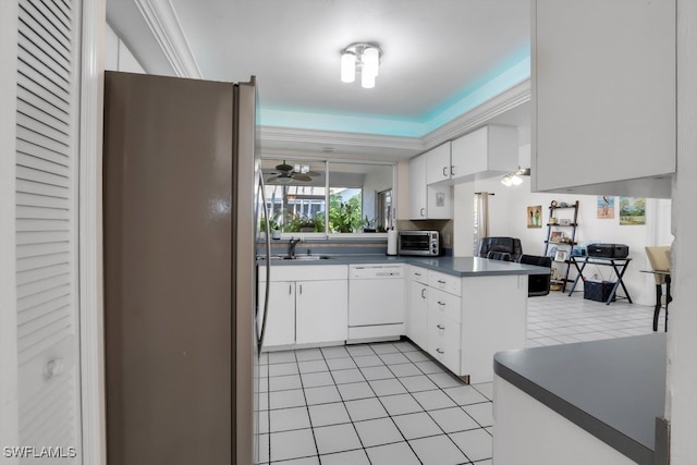 kitchen featuring a peninsula, white dishwasher, freestanding refrigerator, and white cabinets