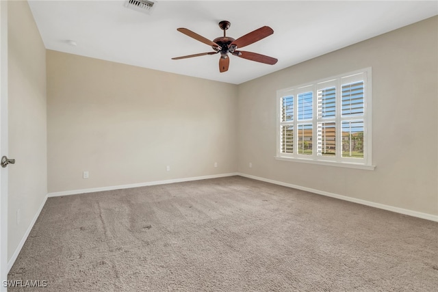 empty room featuring visible vents, a ceiling fan, baseboards, and carpet floors