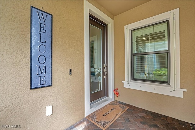 entrance to property with stucco siding