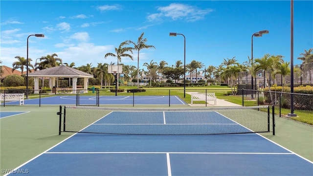 view of sport court featuring fence and a gazebo