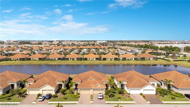 birds eye view of property with a residential view and a water view