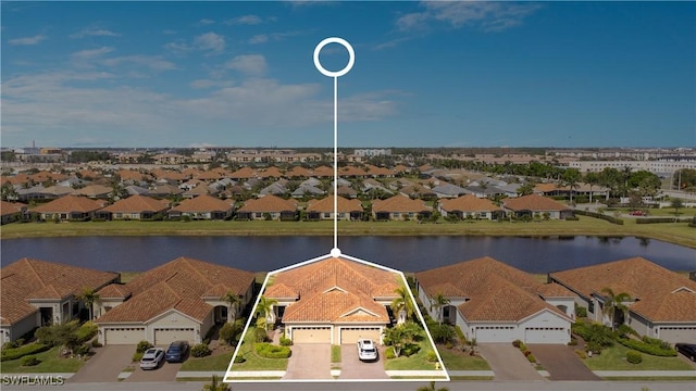 birds eye view of property featuring a water view and a residential view