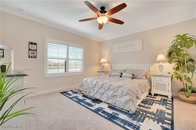 bedroom with a ceiling fan, carpet, ornamental molding, and baseboards