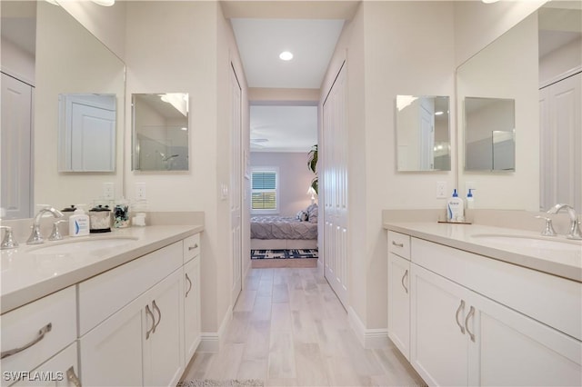 ensuite bathroom with wood finished floors, a closet, vanity, and ensuite bathroom