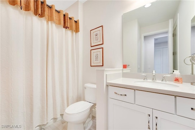 bathroom with toilet and vanity