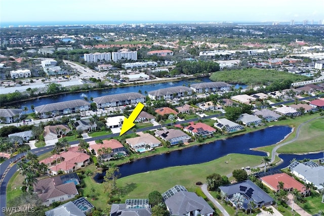 drone / aerial view featuring a water view and a residential view