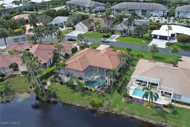 birds eye view of property with a water view and a residential view