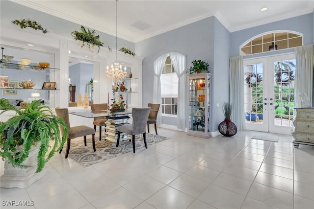 dining room featuring ornamental molding, french doors, light tile patterned floors, and a wealth of natural light